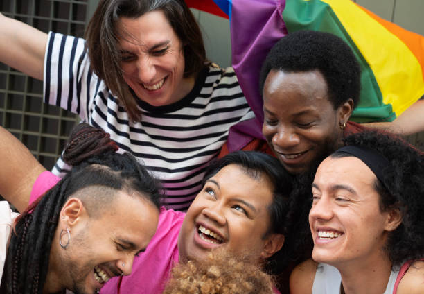 istock Close up of multicultural people smiling and hugging each other. Embracing diversity 2137191743