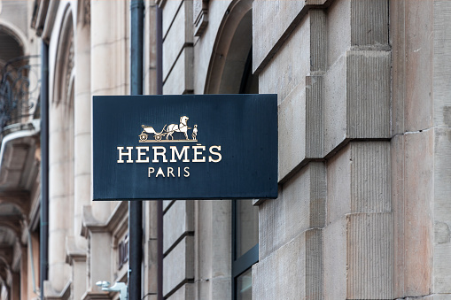 Basel, Switzerland - April 02, 2024: Hermes shop sign in Basel, Switzerland . It is a French fashion house selling luxury articles. Founded in Paris in 1837.