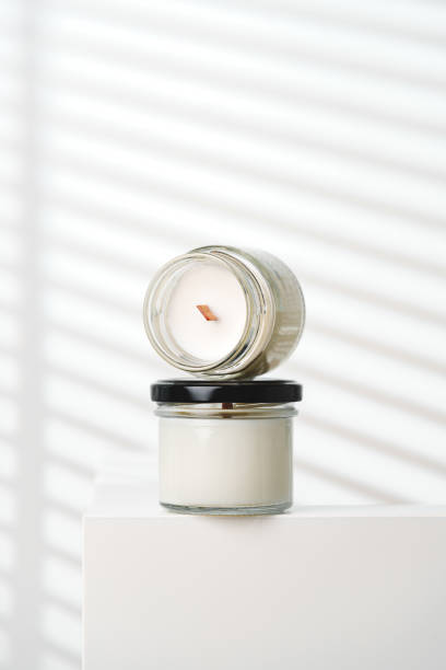 istock Candle With Extinguished Flame Resting on Glass Jar Near Blinds 2137209605