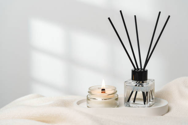 istock Elegant Aroma Diffuser With Reed Sticks And Scented Candle On White Tablecloth 2137215849