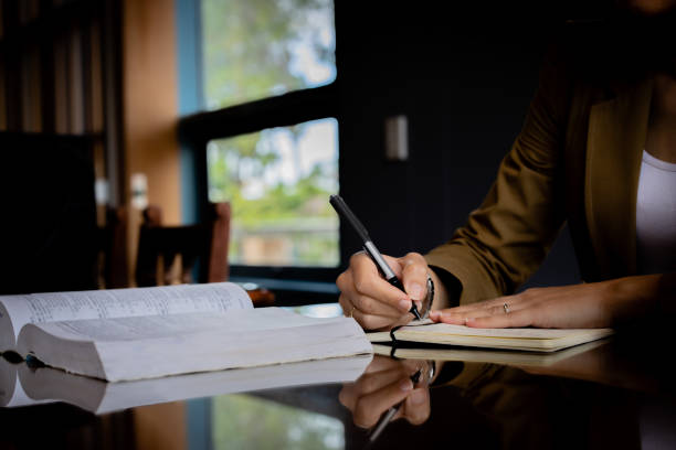 istock Professional writing using a legal notepad and desk. Signing a form in an office, official document 2137227356