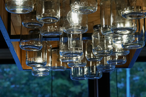 a lot of empty cans with a lighting lamp on the ceiling in the store, a close-up photo