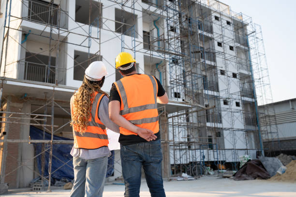 istock Back worker engineer African woman working with caucasian worker at construction site 2137251613