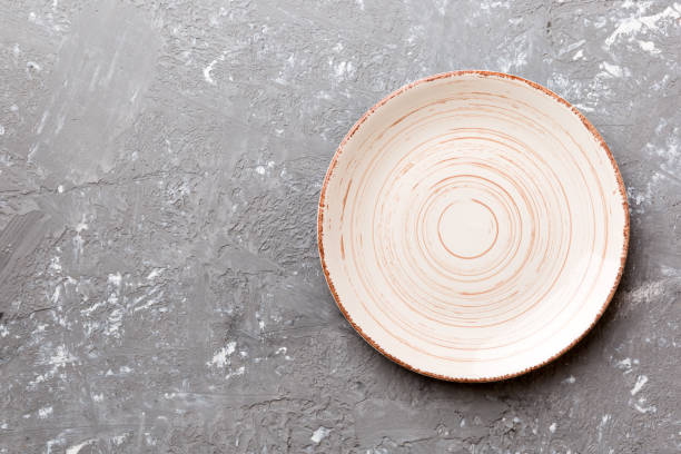 istock Top view of empty colorful plate on cement background. Empty space for your design 2137272244