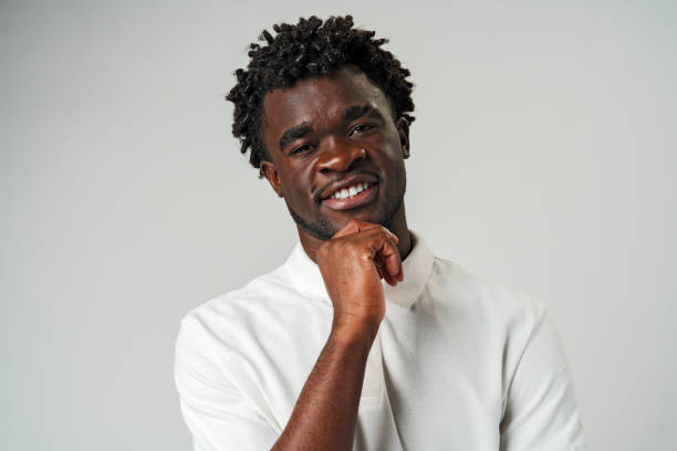 istock African Man in White Shirt Posing for a Picture in Studio. 2137277213