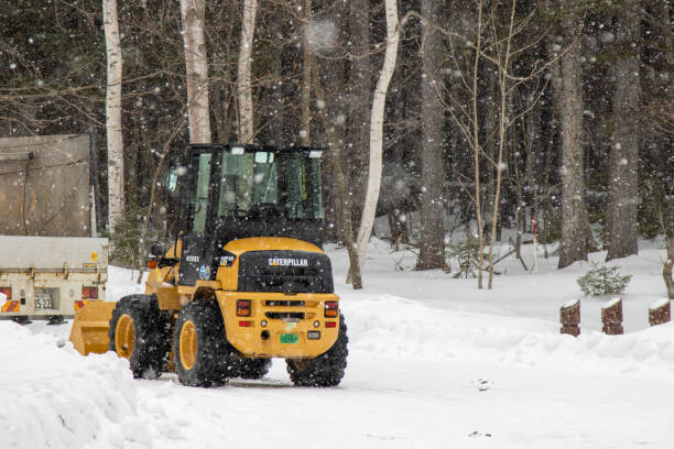 Teshikaga, Hokkaido Japan -March 20, 2024 Caterpillar excavator An American-made excavator during a heavy snow storm