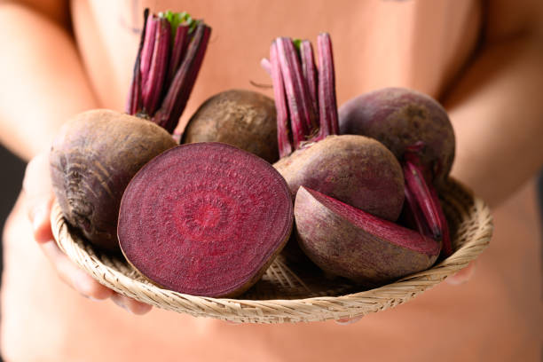istock Fresh beetroot in basket holding by woman hand 2137309068