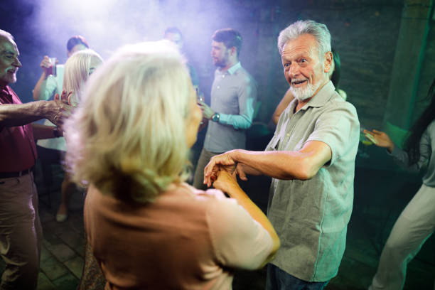 istock Happy mature couple dancing in a disco. 2137323693