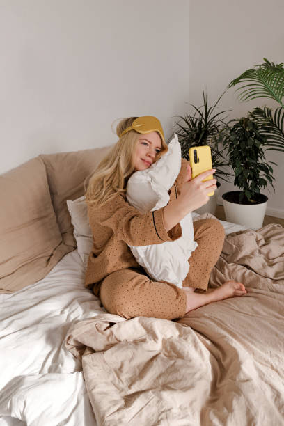 istock Woman in bed with phone 2137324448