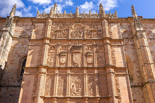 University of Salamanca, front stone Plateresque facade of Escuelas Mayores building with decorative reliefs and figures.
