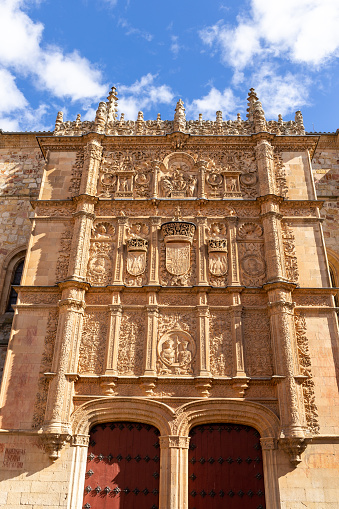 University of Salamanca, front stone Plateresque facade of Escuelas Mayores building with decorative reliefs and figures, main entry gate.