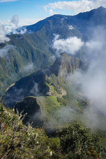 A sweeping, panoramic vista of Machu Picchu and the sacred valley, as seen from Machu Picchu mountain, far about the citadel.