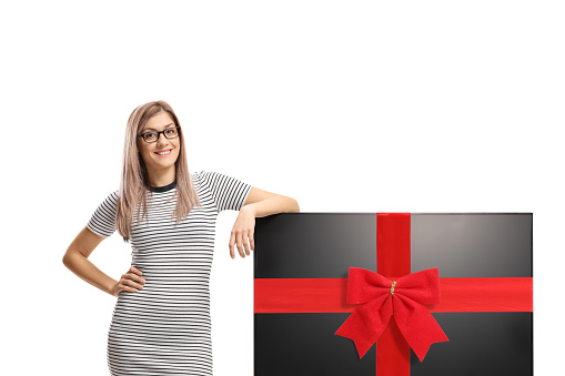 Young woman with a tv tied with a red ribbon isolated on white background