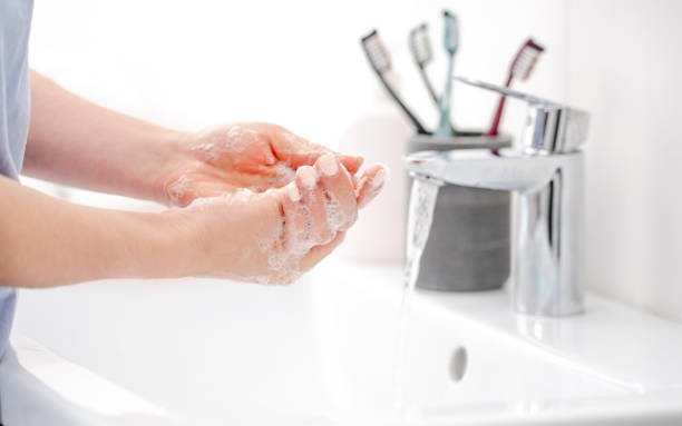 istock Girl Washes Hands With Liquid Soap 2137405335