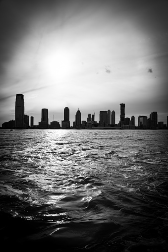 Black and white capture of Jersey City skyline from Battery Park in Manhattan, NYC.