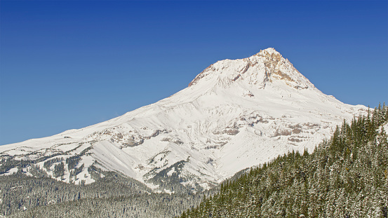 Aerial view of snow covered peak of Mt. Hood on sunny day in Oregon, USA.