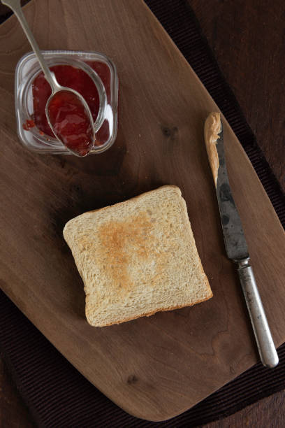 Grilled peanut butter and strawberry  jelly sandwich on a rustic background