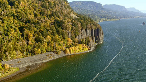 Aerial view of highway along cliff by Columbia River on sunny day, Oregon, USA.