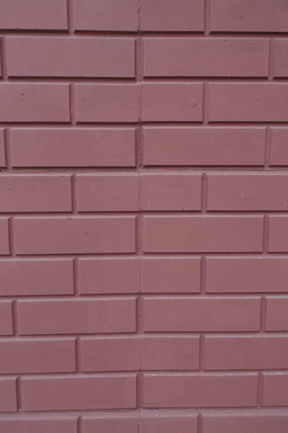 Wall made of reddish brown painted brick veneer