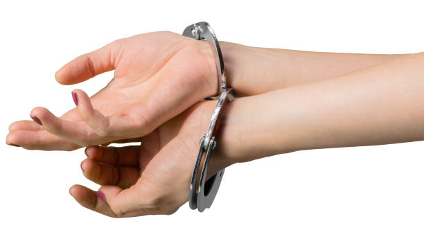 istock hand wearing handcuffs isolated on white background 2137457881