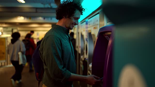 An Adult Man Buying Train Ticket Using His Smartphone At The Paris Metro Station