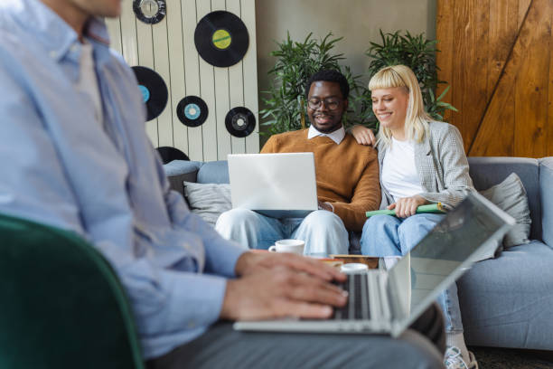 istock Cheerful diverse young coworkers chatting in modern co-working space 2137490910