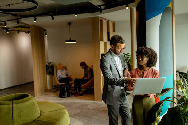 istock Modern office collaboration, two professionals engage in a creative brainstorming session 2137491691