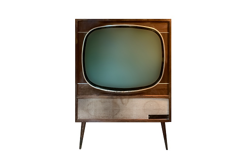 This is a photograph of a small retro television from the 1980s in front of a vintage wood paneled wall.