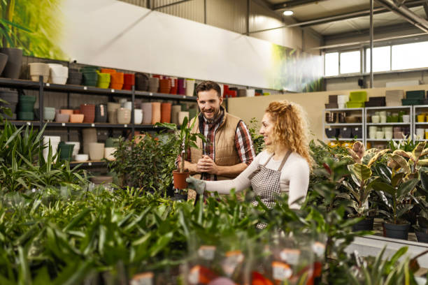 istock Florist Worker Assists Customer with Plant Selection 2137512663