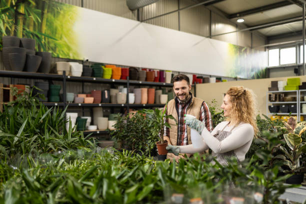 istock Florist Worker Serves Customer in Plant Store 2137513091