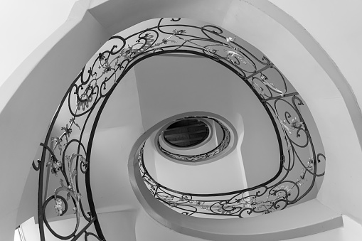 man rising surreal spiral stairs