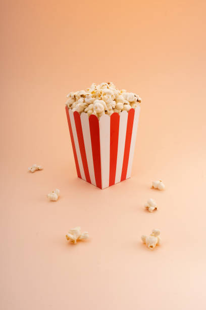istock Striped popcorn bucket on a tan background. 2137517987