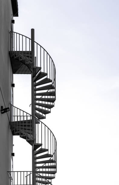 istock Spiral fire escape at building against sky 2137531859