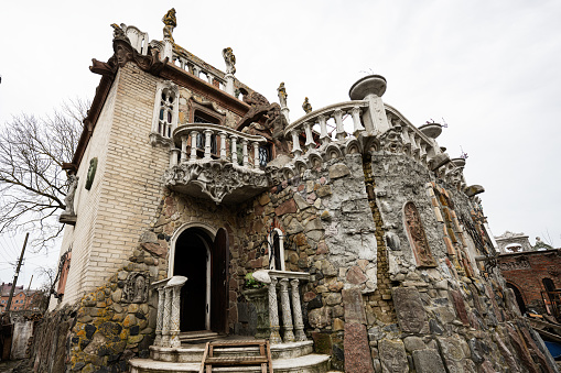 Lutsk, Ukraine - March, 2024:  House of thousand faces by sculptor Golovan. Ornate and eclectic stone mansion resembling a fairy tale castle with artistic details and sculptures.