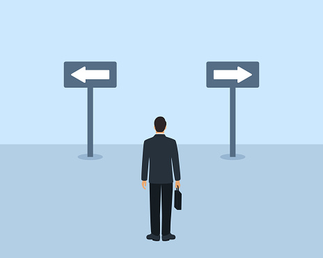 Rear View Of Businessman Standing On A Crossroad And Looking At Arrows Pointing In Different Directions. Opportunity, Decision And Choice Concept