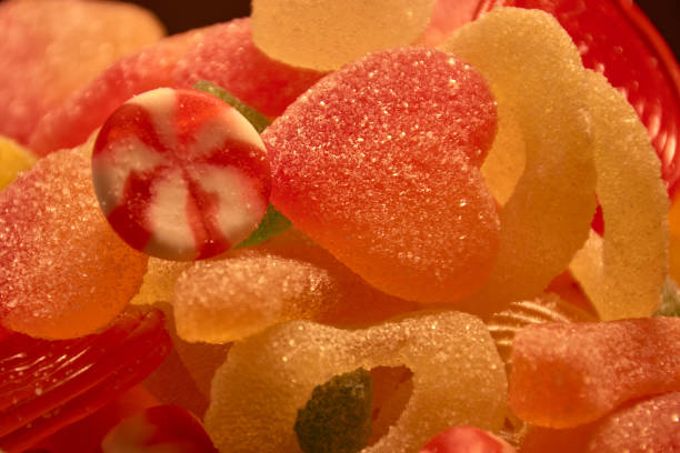 Delicious multicolored fruit jelly. Unhealthy shiny candies in bulk. different gelatin photo close up. Tasty sweets in the candy store. Nobody