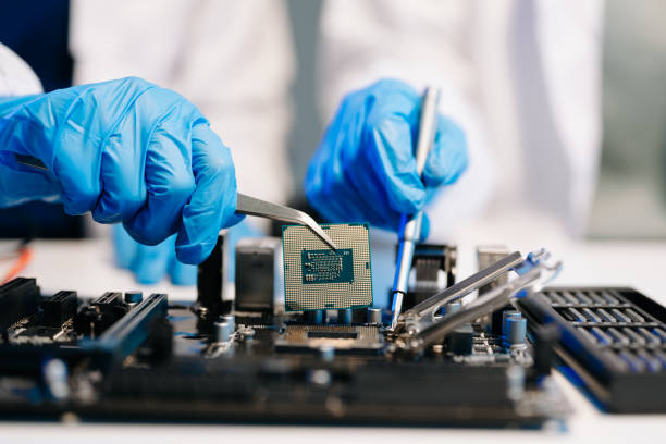 istock The technician is putting the CPU on the socket of the computer motherboard. electronic engineering electronic repair, electronics measuring 2137586362