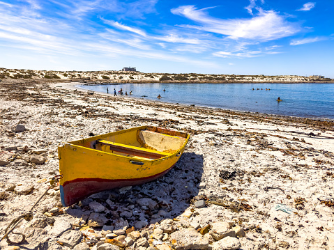 Small fishing rowboat on beach in small West Coast town of Port Nolloth, South Africa