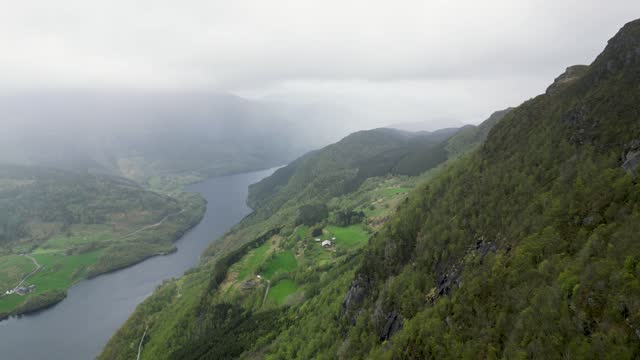 Drone video of Stolanuten cliff and hill top in Nedstrand, Norway, overlooking Lysevatnet Lake.
