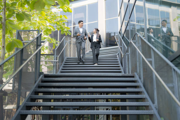 istock Business colleagues conversing on staircase 2137604761