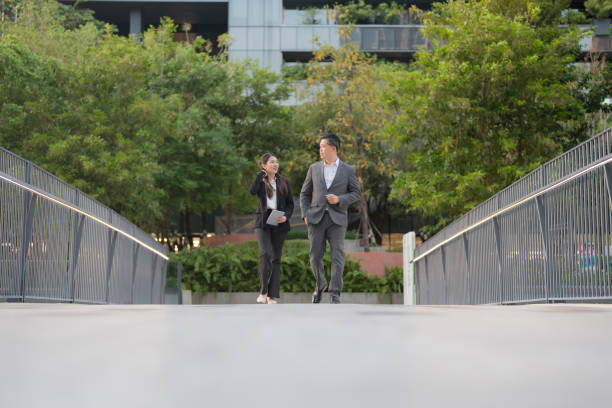 istock Business professionals walking in modern urban setting 2137652608