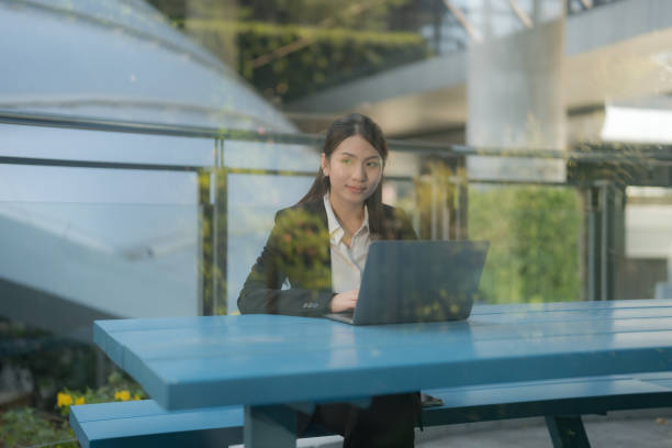 Professional woman working outdoors on laptop