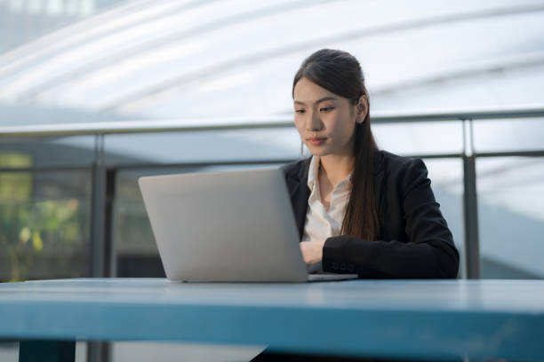 istock Professional woman working outdoors on laptop 2137653654