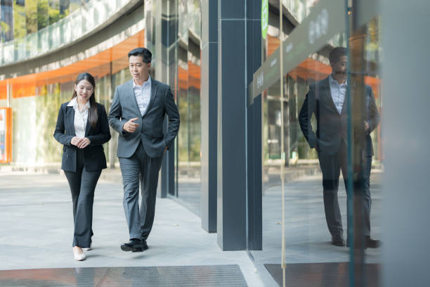 istock Business colleagues walking together in modern business district 2137654712