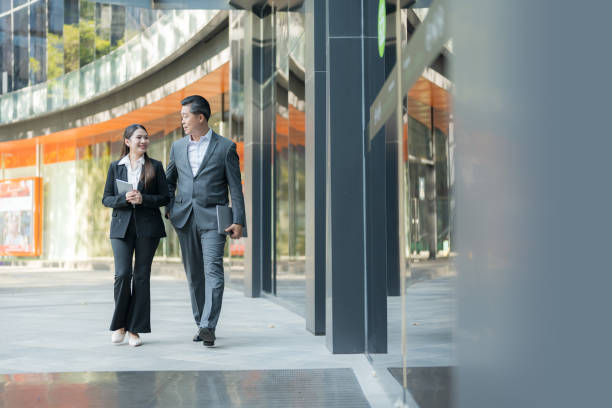 istock Business colleagues walking together in modern business district 2137654713