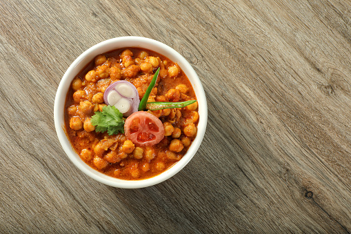 Close up cooked chickpea bowl on wooden table