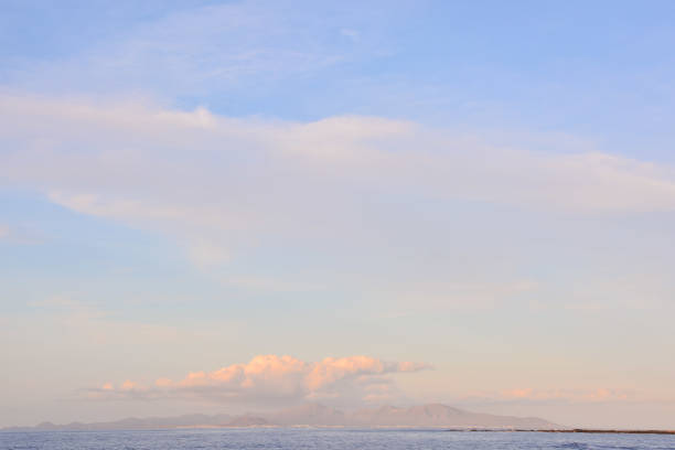 Beautiful view of Cape Town and its famous Table Mountain from a deserted beach at Milnerton, with plenty of copy space in the sky and beach sand.