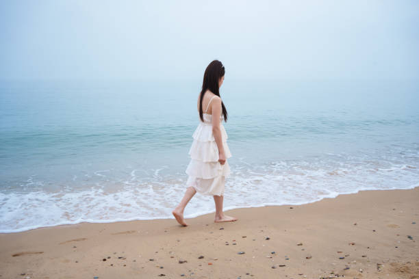 young woman walking on the beach