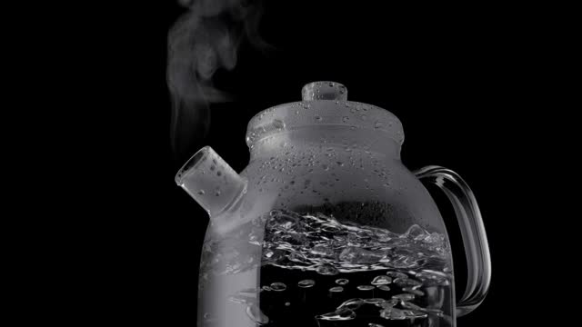 Water bubbles into a transparent pot, boiling water for a tea ceremony with a glass teapot. The essence of brewing tea, black background. HDR, 4K.