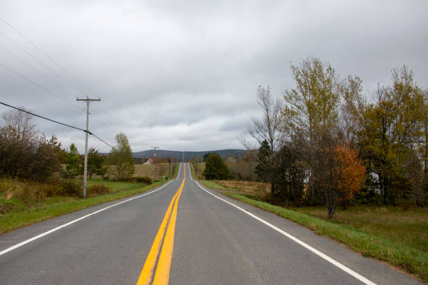 istock Empty road with yellow lines in rural landscape. 2137715496